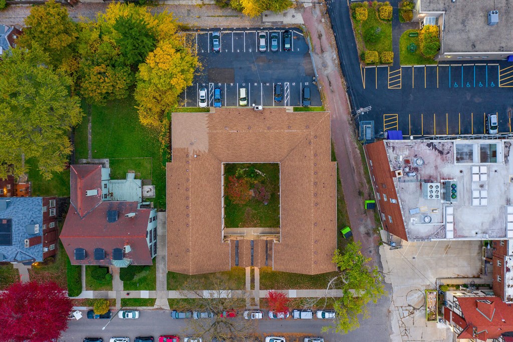 An aerial view of a parking lot and a building with a red roof.