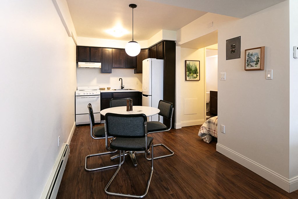 A kitchen with a table and chairs in the middle of the room.
