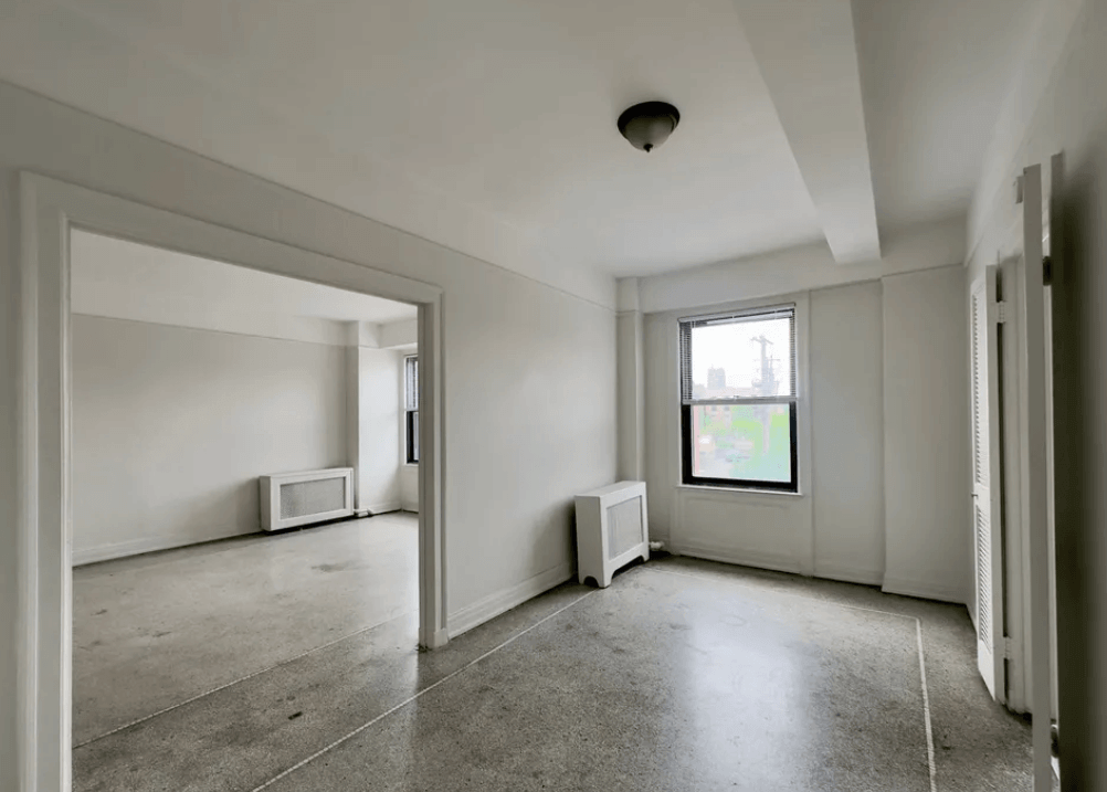 A room with a window and a television set.