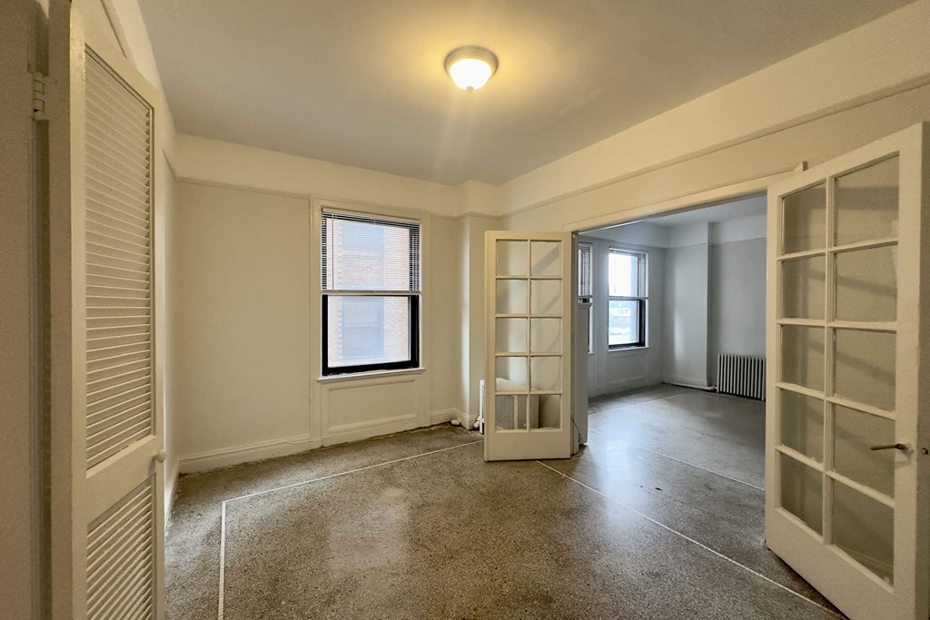 A room with a window and a door.