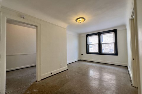 A room with a window and a door.