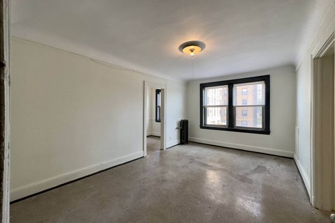 A room with a window and a door.