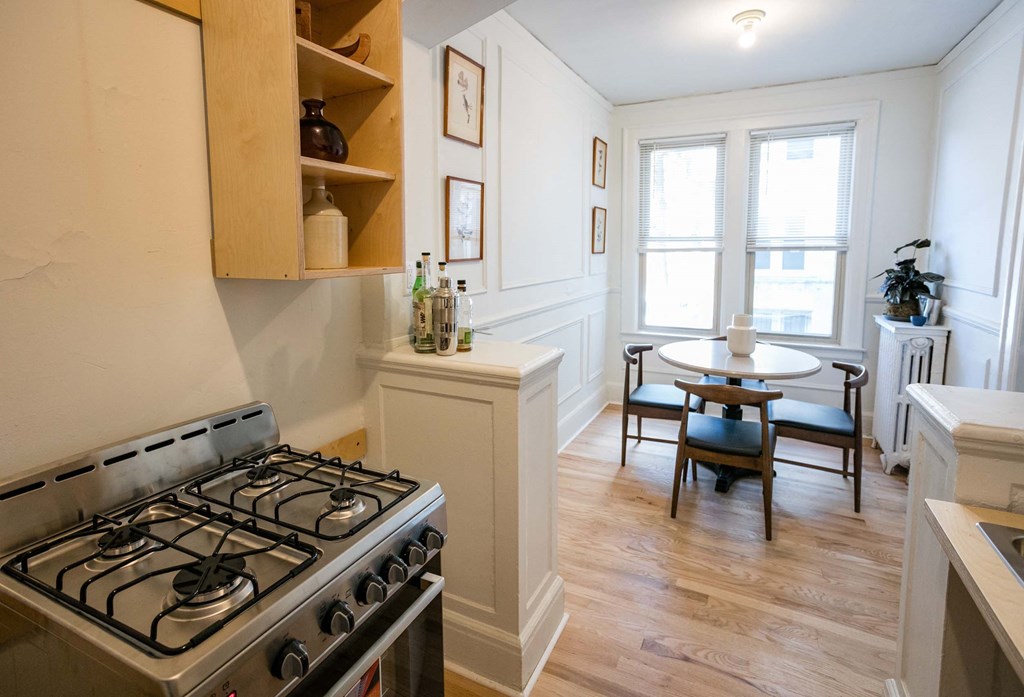 A kitchen with a stove and a table.