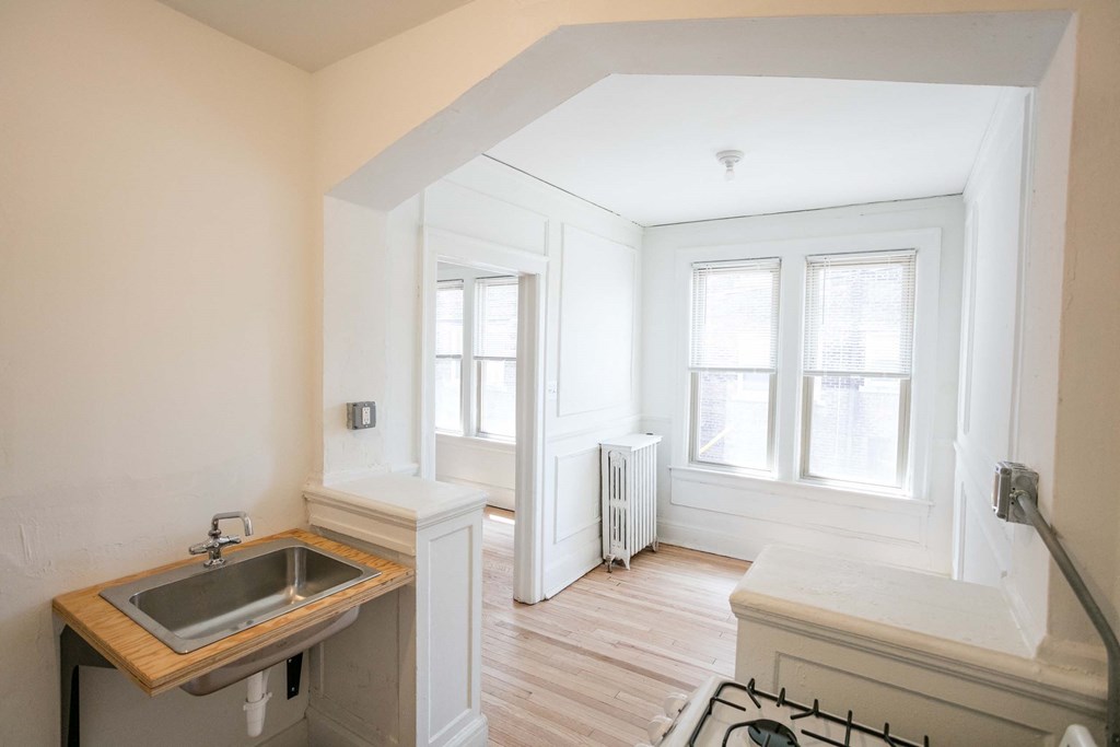A kitchen with a sink and a window.
