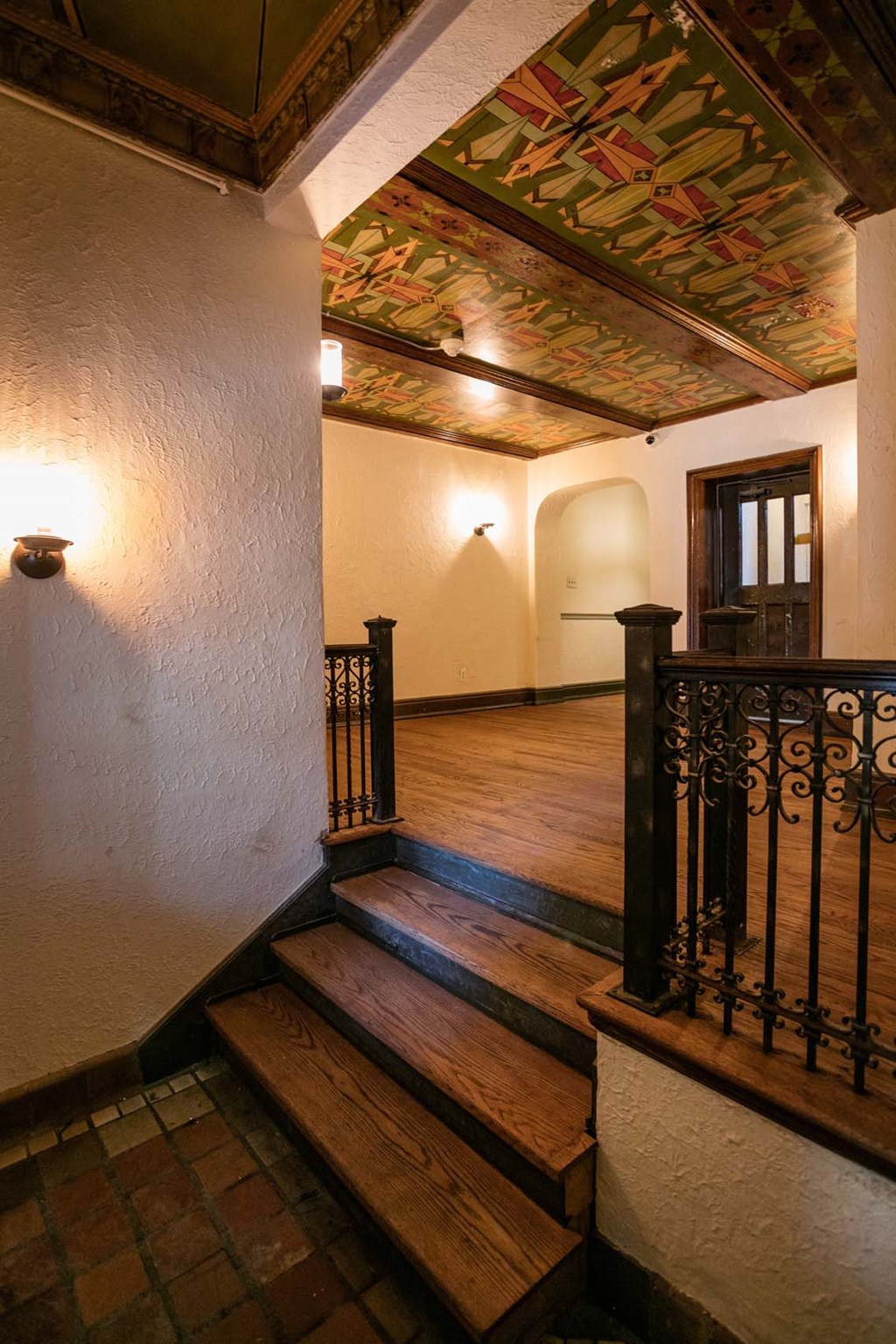 A staircase with a metal railing and wooden steps.