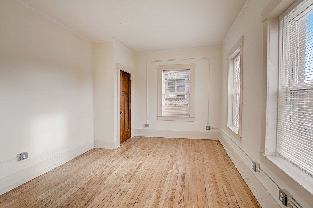A room with wooden floors and white walls.