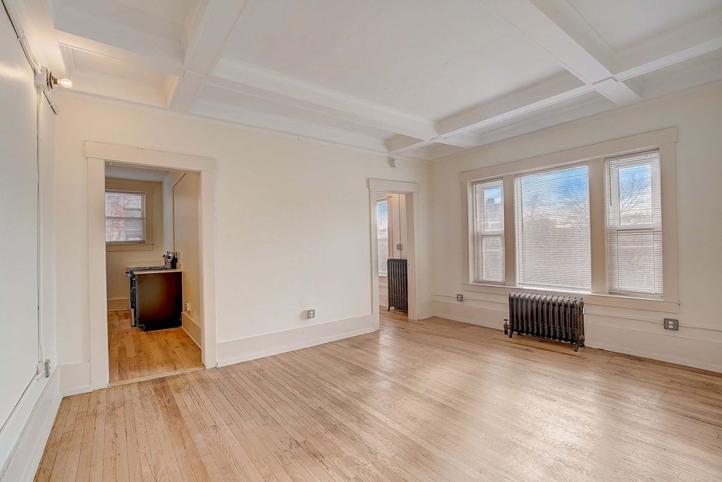 A room with wooden floors and white walls.
