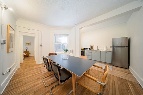 A kitchen with a table and chairs in the middle of the room.