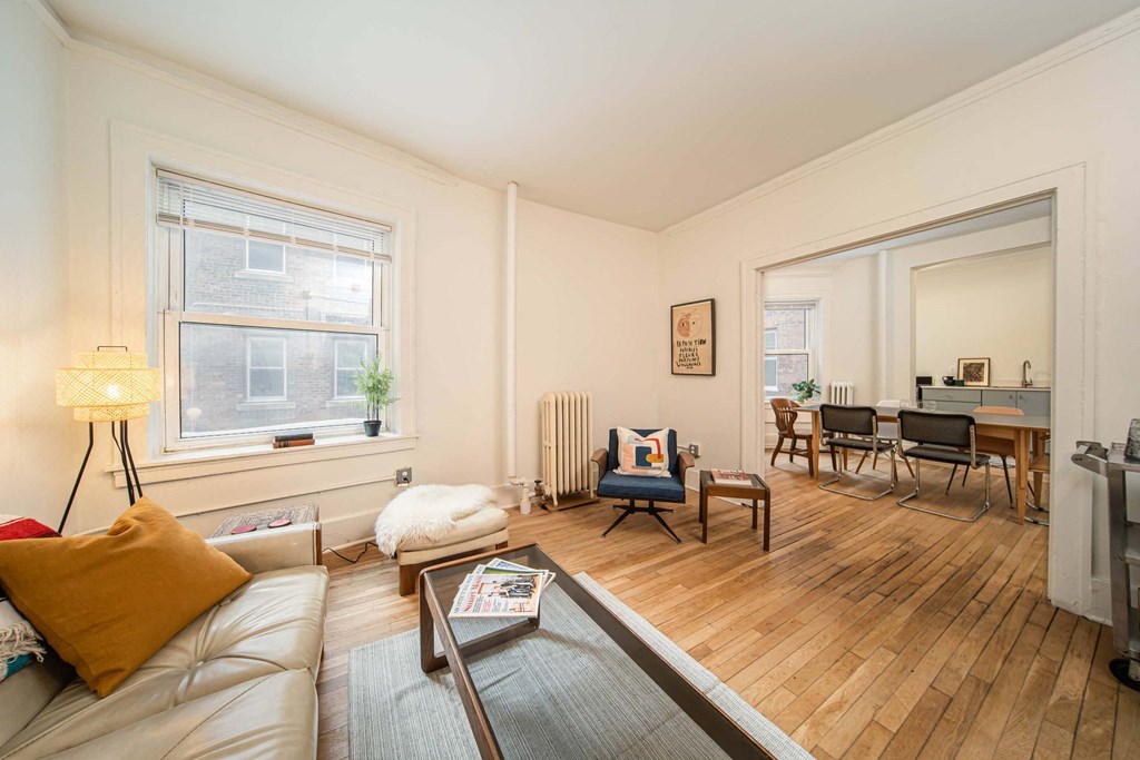 A living room with a couch, chair, and coffee table.