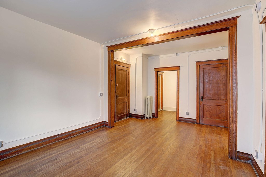 A room with wooden floors and white walls.