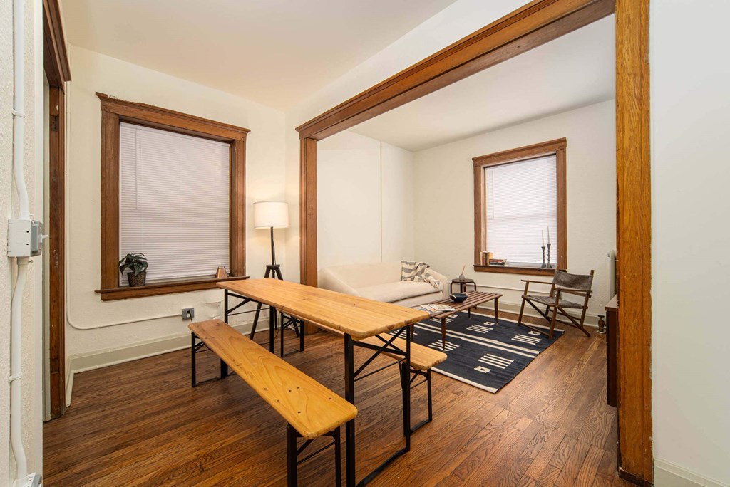 A room with a long wooden table and chairs.
