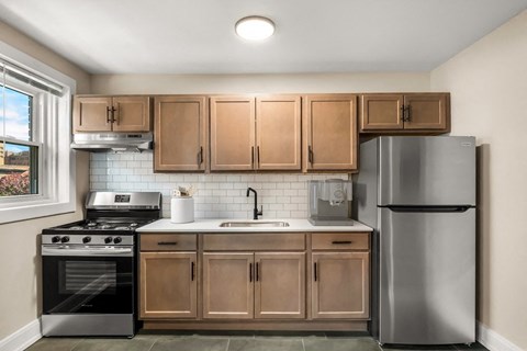 A kitchen with wooden cabinets and stainless steel appliances.