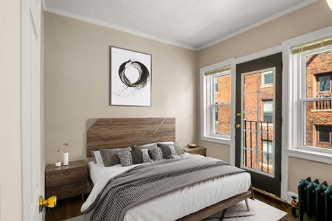 A bedroom with a large bed and a picture on the wall.