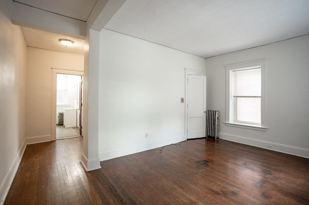 A room with wooden floors and white walls.