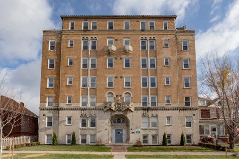 A large, two-story building with a balcony on the second floor.