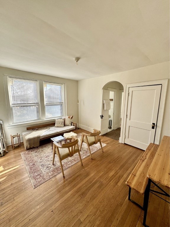 A room with a bed, a table and chairs, and a window.