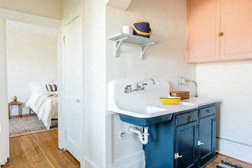 A bathroom with a blue sink and a white countertop.