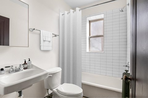 A white toilet sits next to a sink in a bathroom.