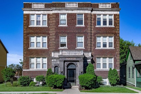 A red brick building with the word "MAYOR" on the front.