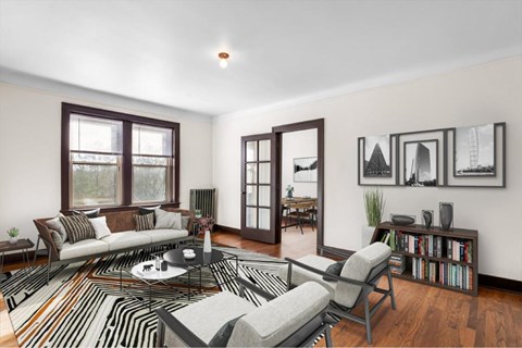 A living room with a white couch, a coffee table, and a striped rug.