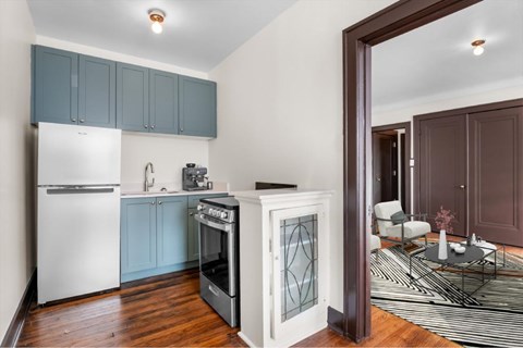 A kitchen with a white refrigerator and a stainless steel oven.