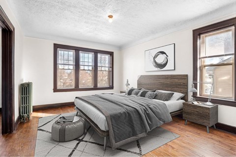 A bedroom with a large bed and a window.