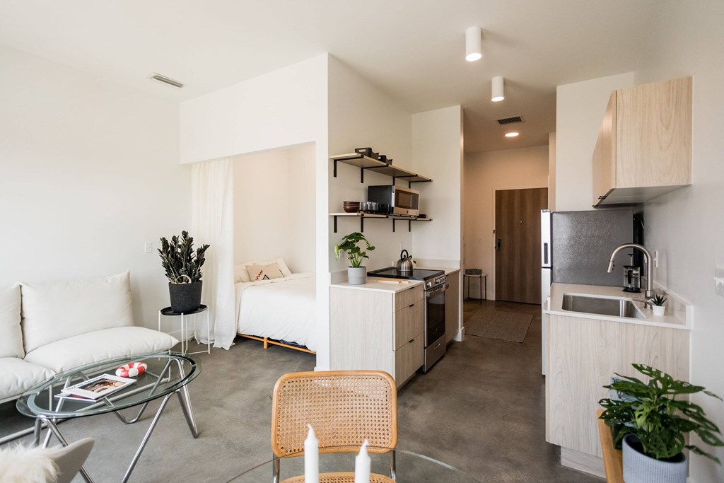 A modern kitchen with a dining table and chairs.