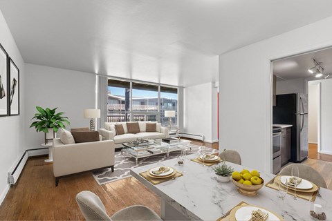 A modern living room with a dining table set for two.