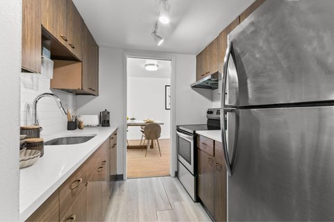 A modern kitchen with a stainless steel refrigerator.