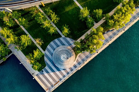 A large circular structure sits in the middle of a plaza.
