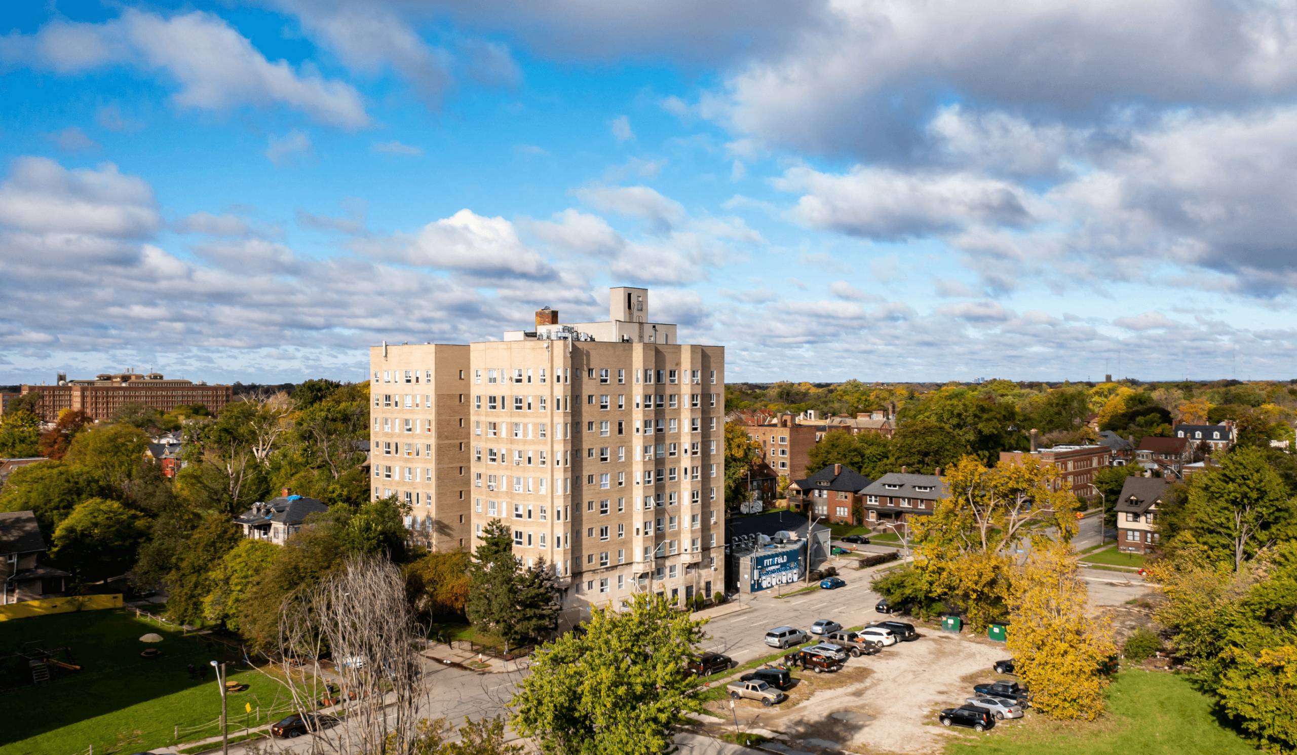 A large building with a parking lot in front of it.