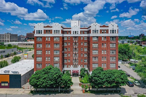 A large red brick building with a white trim around the windows and roofline.