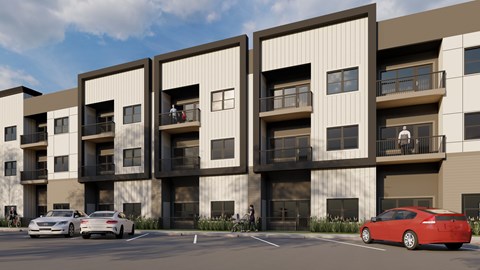 A red car is parked in front of a building with three balconies.