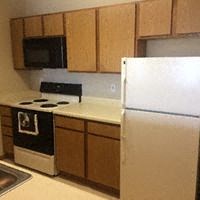 a kitchen with a white refrigerator and a stove