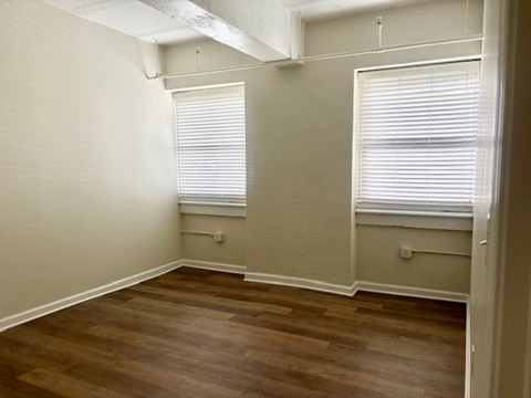 A room with wooden floors and white walls.