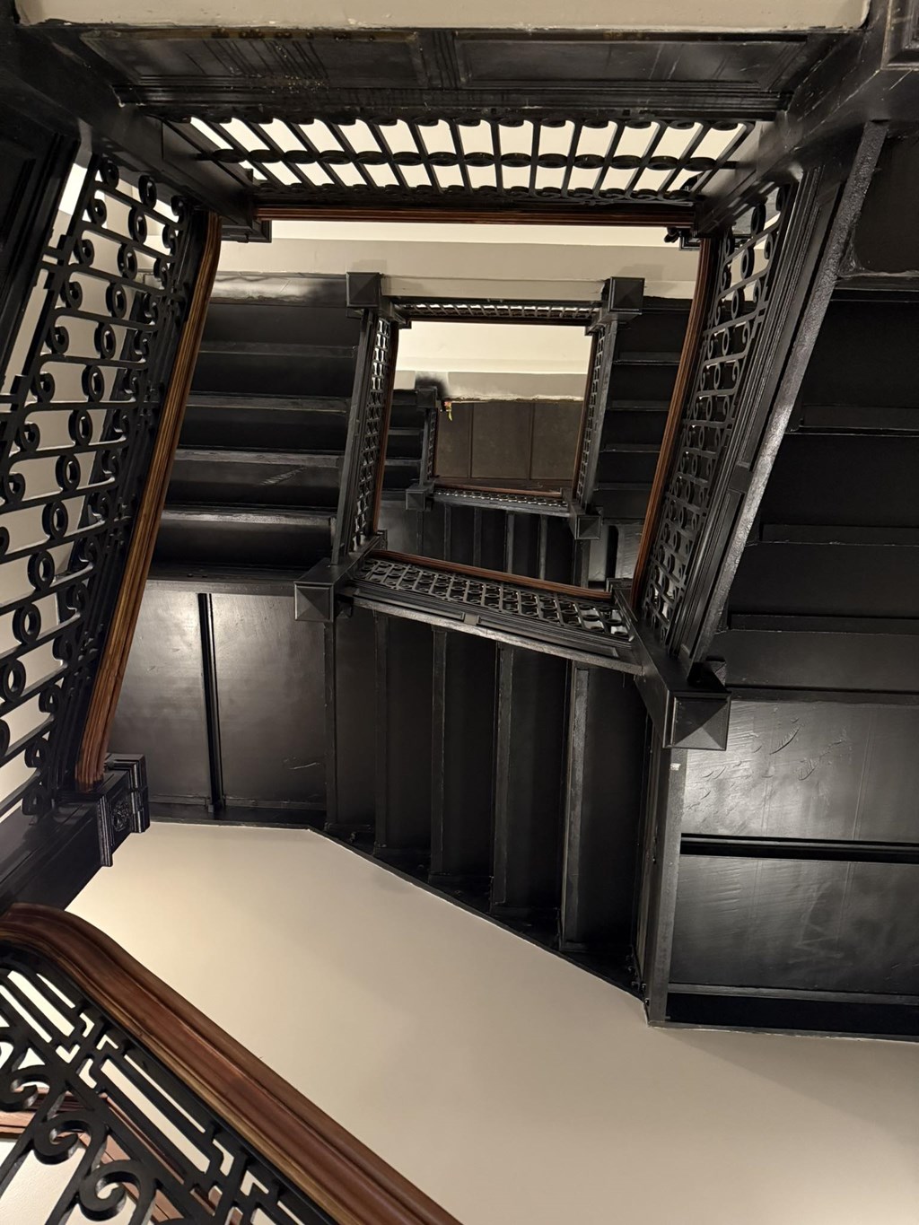 A staircase with a mirror on the side.