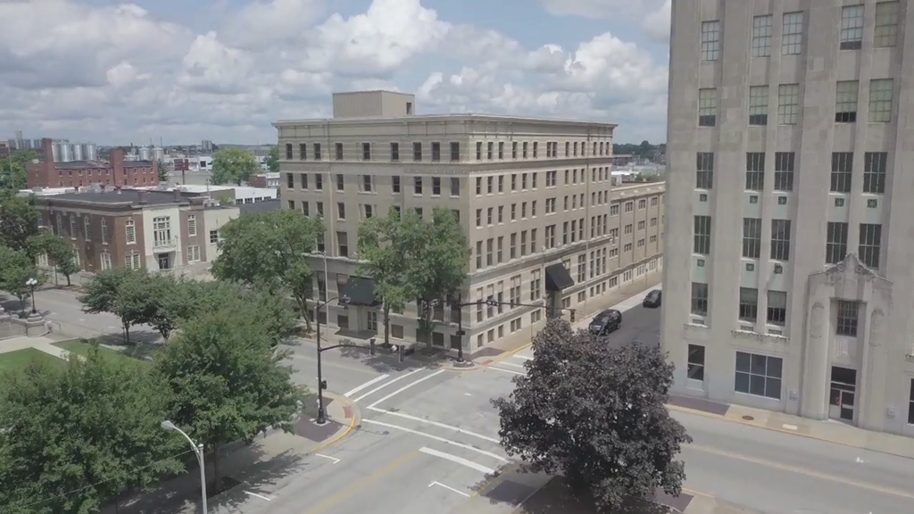 an aerial view of a city street with buildings and trees