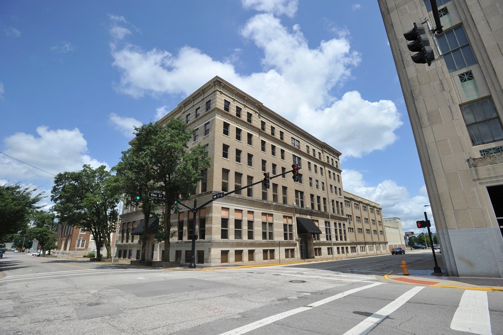 a large building on the corner of an empty street