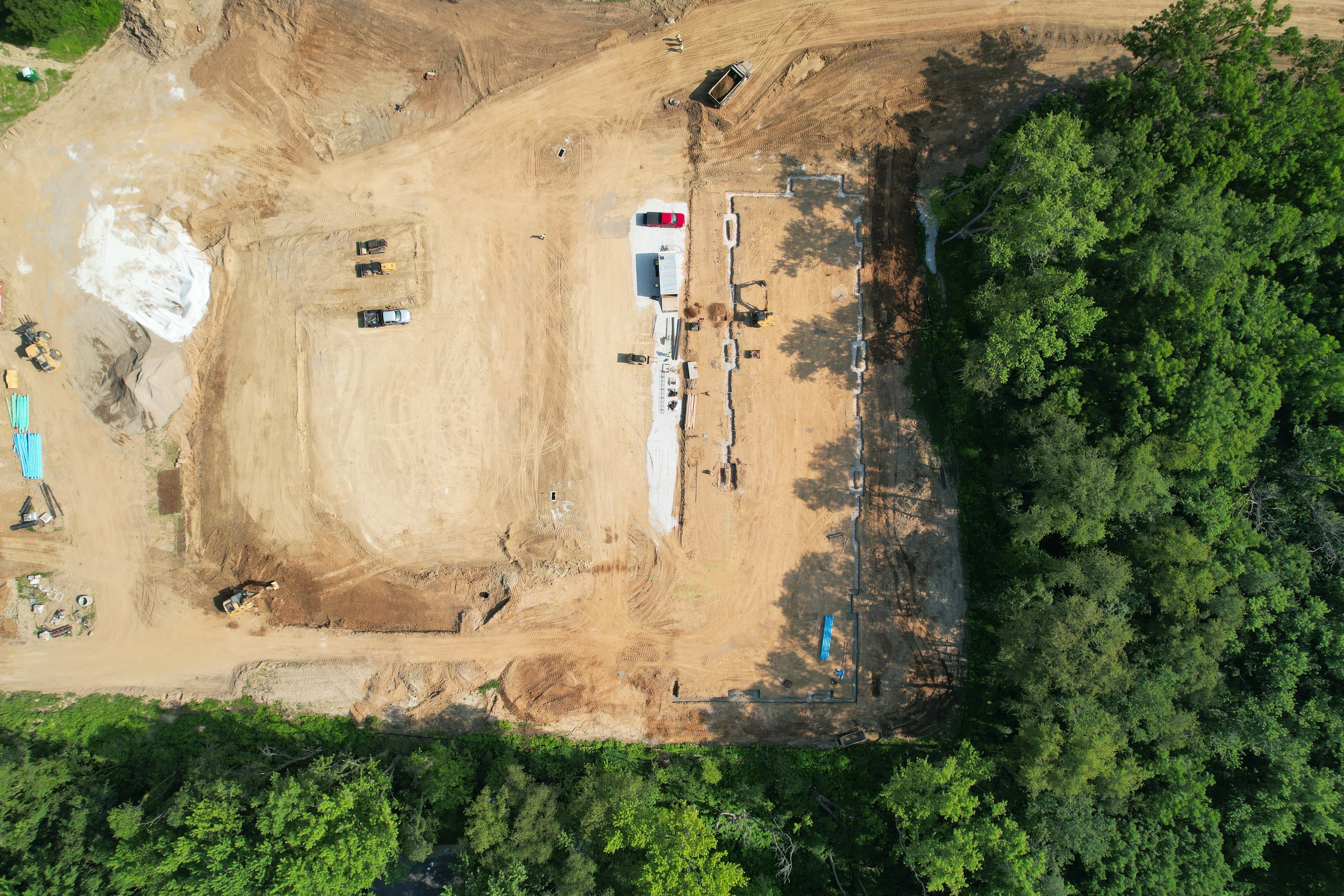 An aerial view of a construction site with a large building under construction.