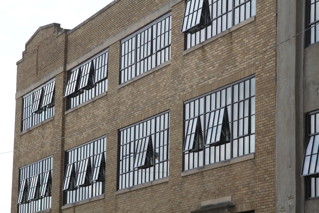 a large brick building with windows with sails in the windows