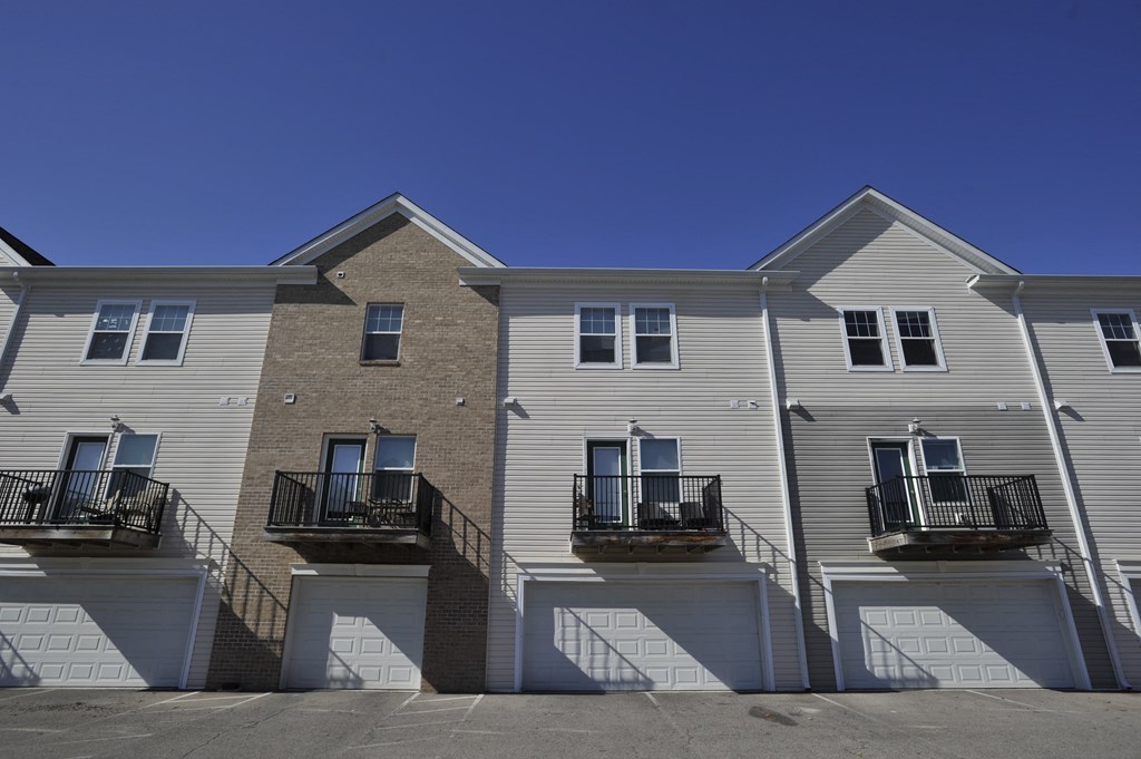 a row of town houses with balconies and a blue sky
