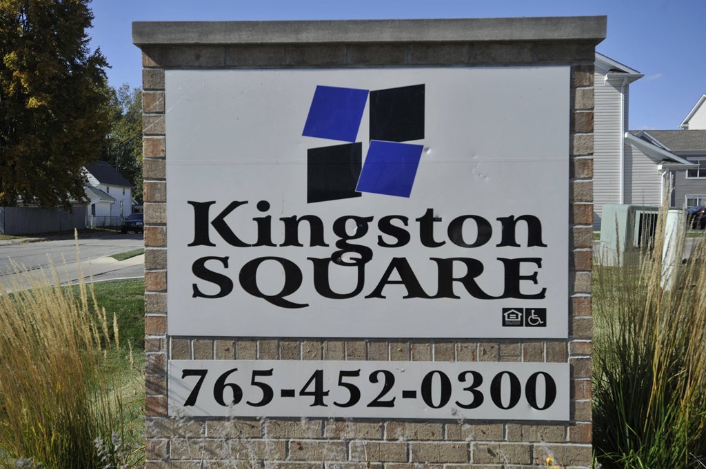 a sign in front of a house