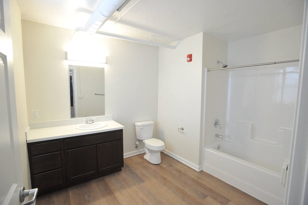 a bathroom with a shower toilet and sink and a mirror