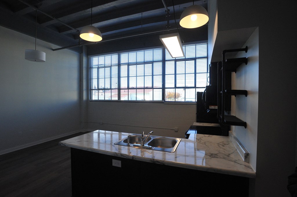 an empty kitchen with a sink and a window