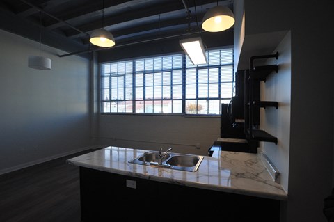 an empty kitchen with a sink and a window