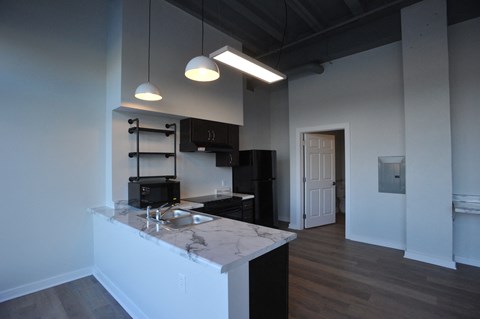 a kitchen with a marble counter top in a living room