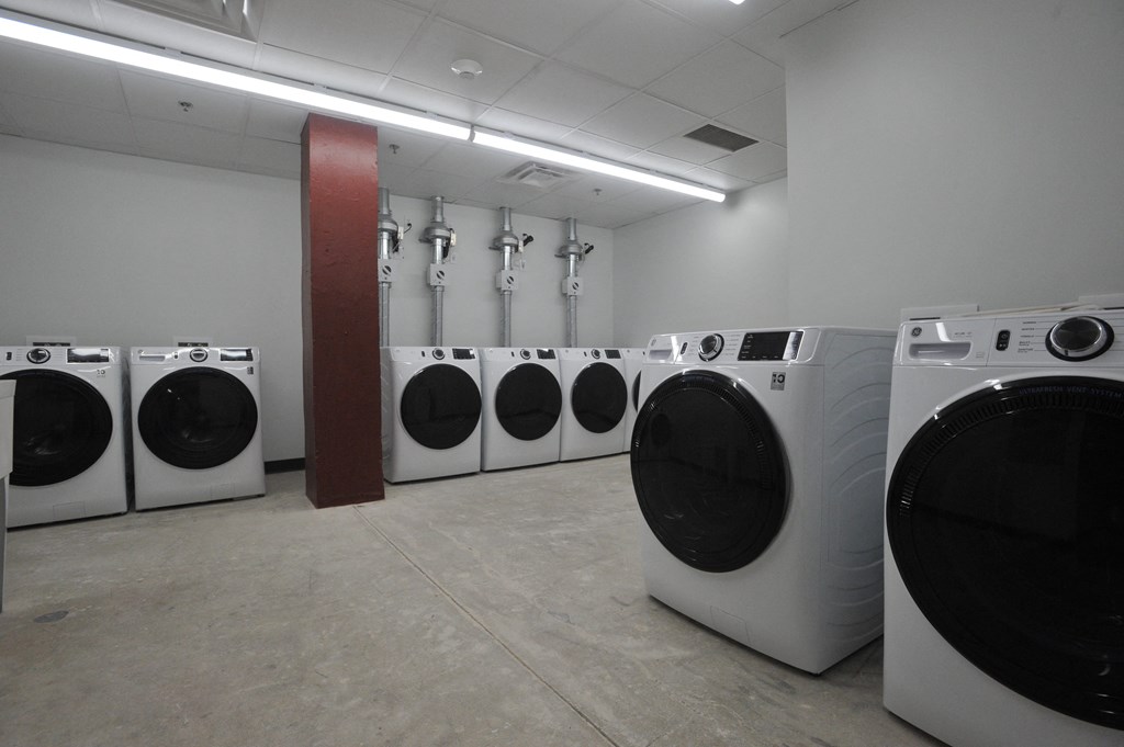 a row of washing machines in a laundry room