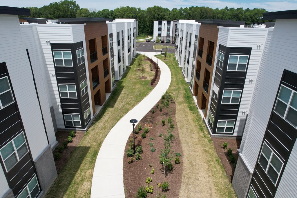 an aerial view of a group of town houses with a sidewalk