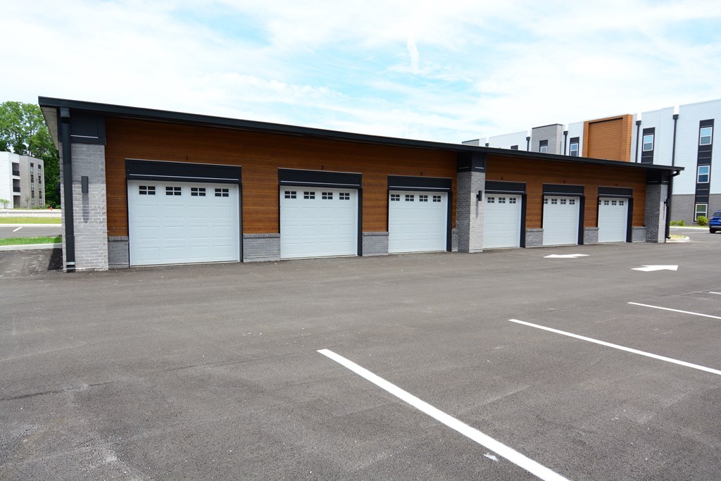 a row of garage doors in a parking lot