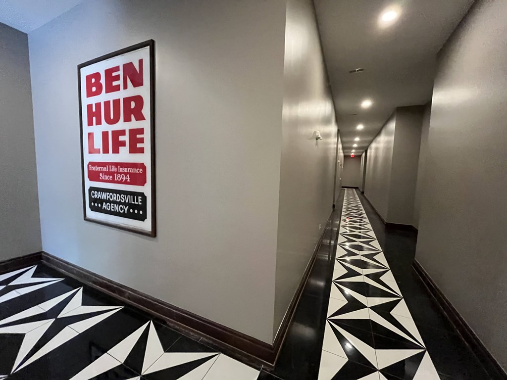 A hallway with a Ben Hur Life sign on the wall.